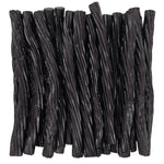 Black licorice twists neatly arranged together.