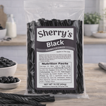 Packaged black licorice sticks with Sherry's Licorice Black label on a wooden surface.