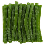 Green apple licorice twists neatly arranged together.