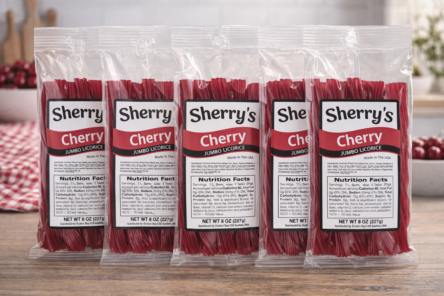 Five packages of Sherry's Licorice Cherry Jumbo Licorice on a wooden surface with a blurred background.